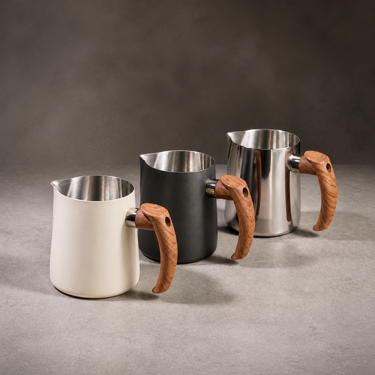 Three 600 ml latte art milk pitchers with wood-look handles